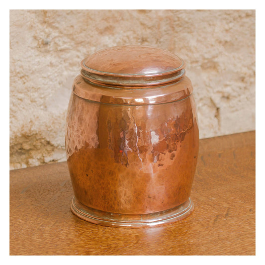 An Arts & Crafts Lakes School hand beaten copper jar by Fanny Carter