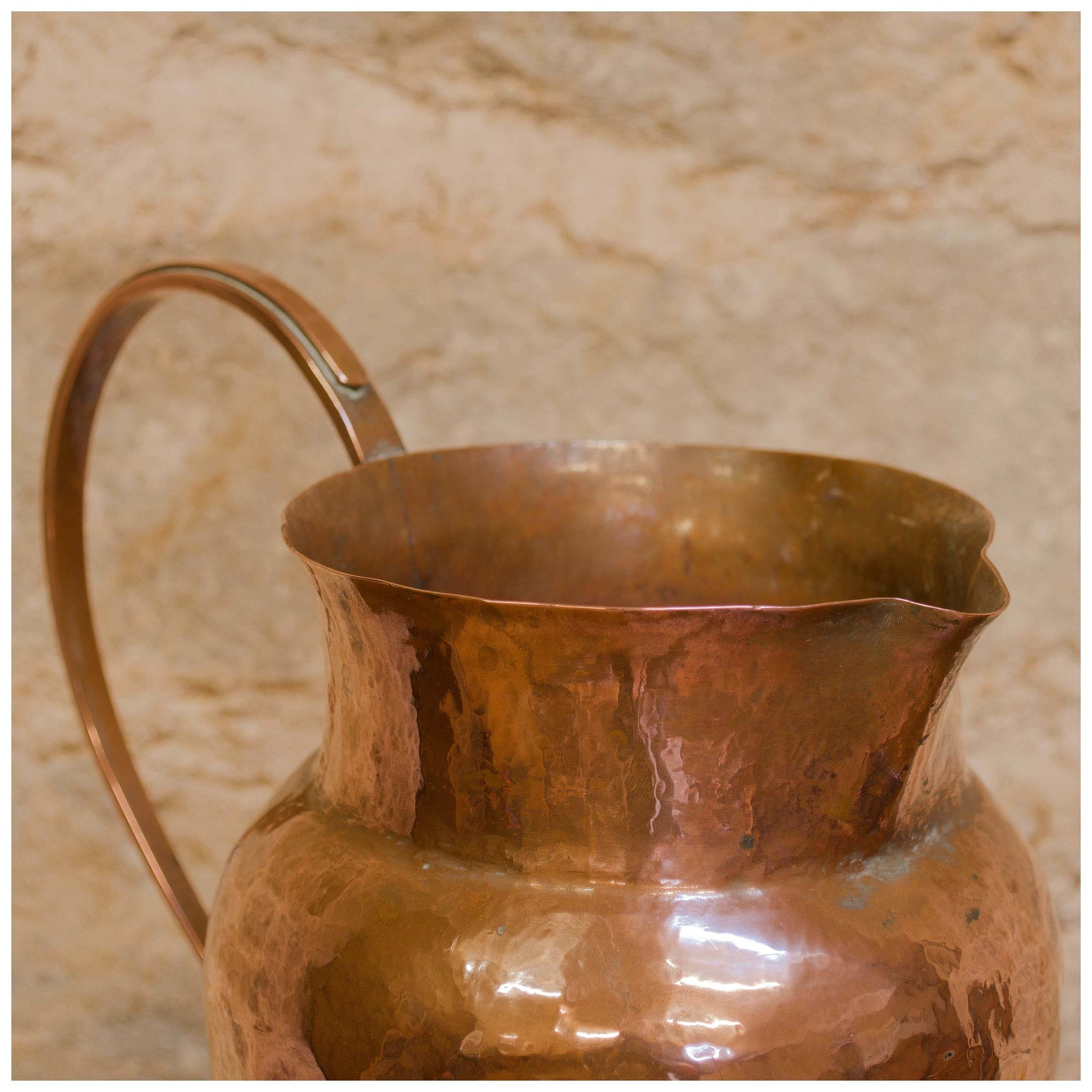 An Arts & Crafts Lakes School hand beaten copper jug by Fanny Carter